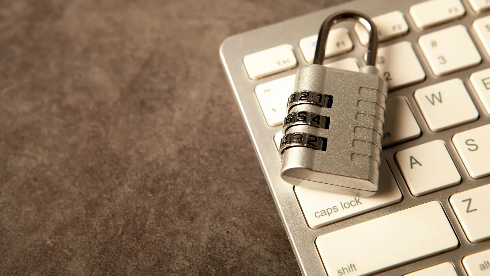 Combination padlock resting on a computer keyboard