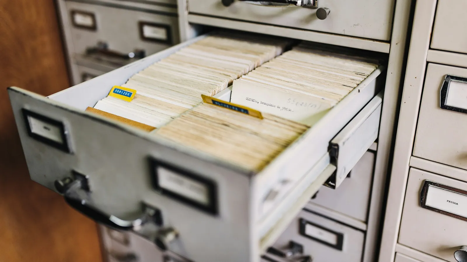 Open drawer of a metal card-file cabinet full of index cards